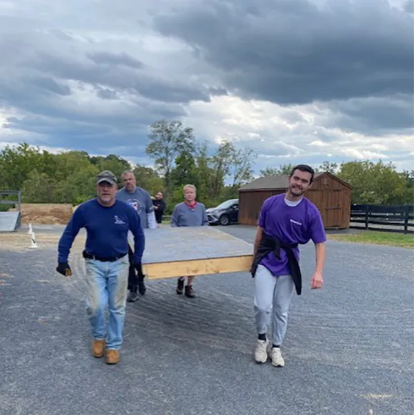 Volunteers carrying platform together