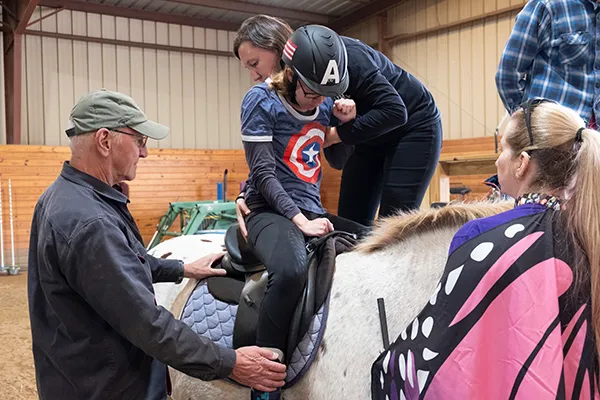 Staff helping rider mount