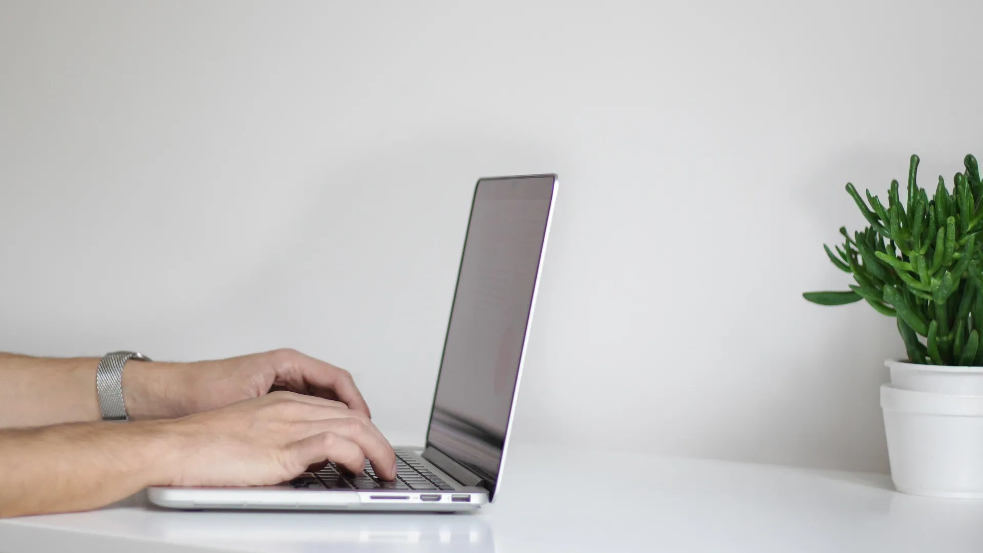 Hands typing on laptop computer